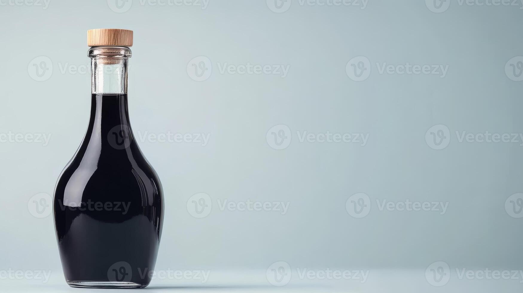 Bottle of balsamic vinegar on grey photo
