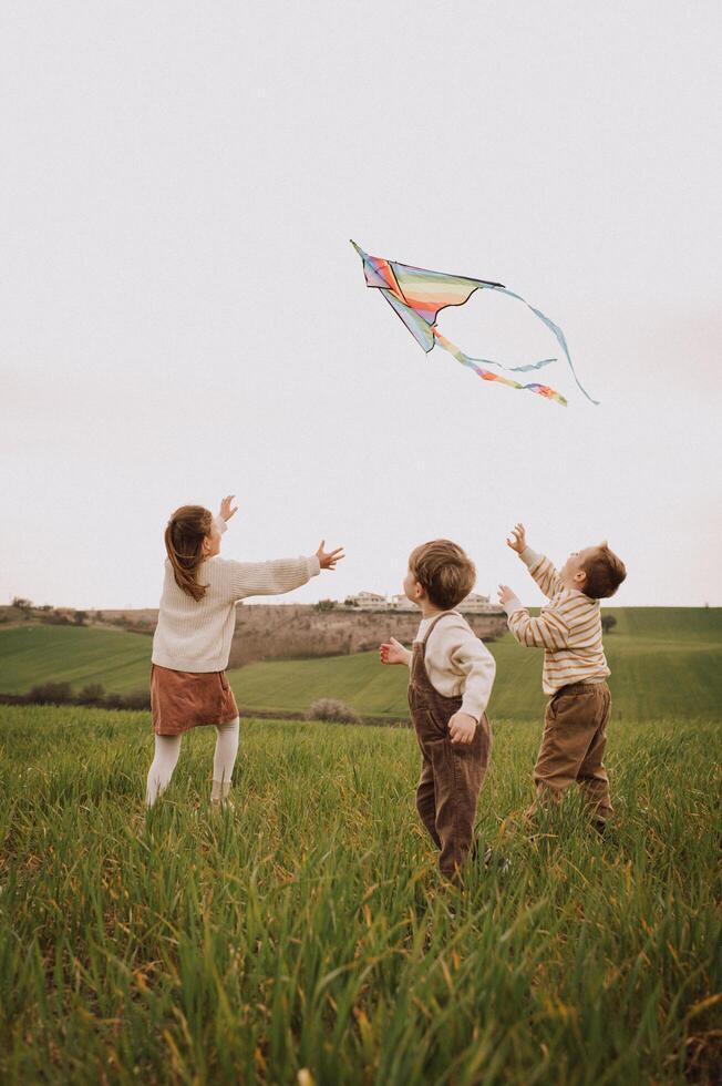 A warm breeze lifts the kite higher while little feet race through the open field. photo