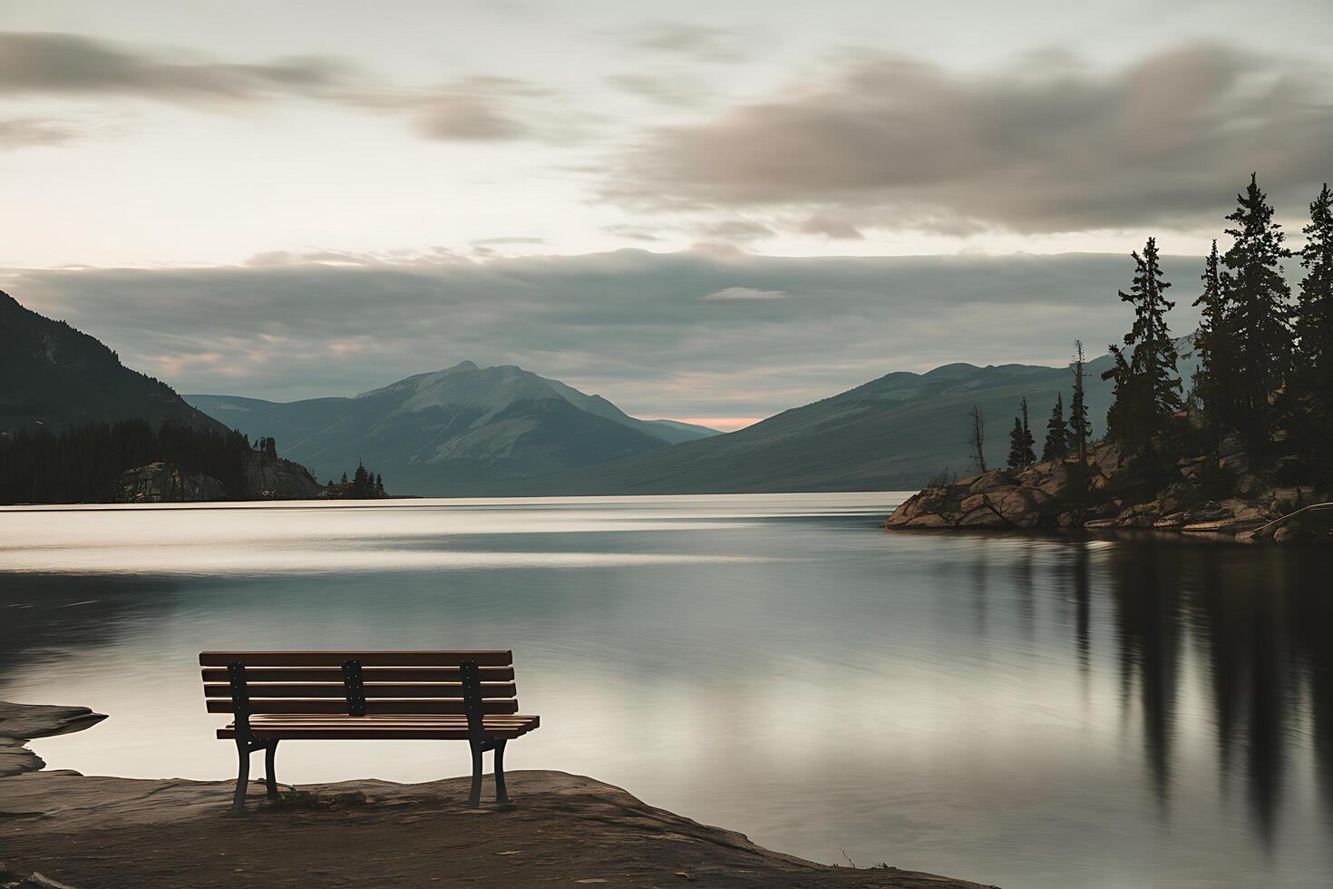 A bench sitting on the shore of a lake photo