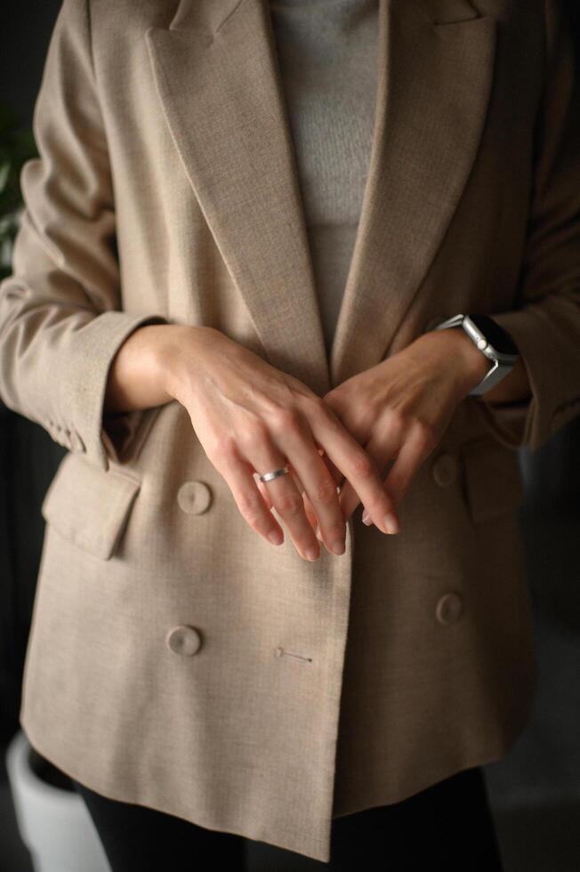 Hands gently resting on a blazer, highlighting elegance and sophistication. photo