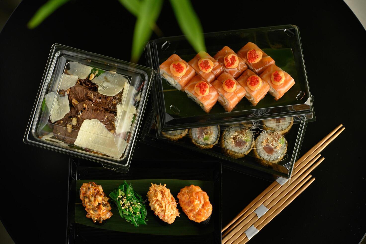 The rich colors of salmon, tuna, and avocado contrast against the deep black tableware, creating a perfect harmony of flavor and presentation. photo