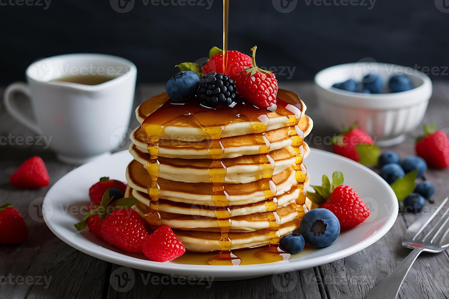 A stack of pancakes with syrup being poured over them photo