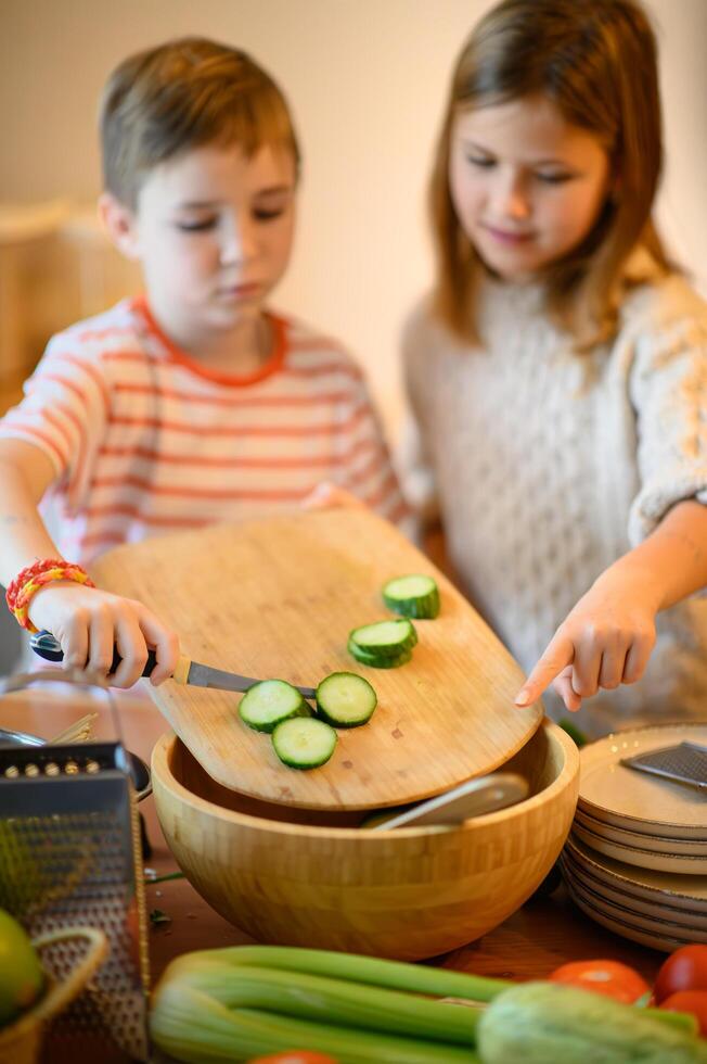 Child hands move quickly, cutting and arranging the vegetables with excitement photo