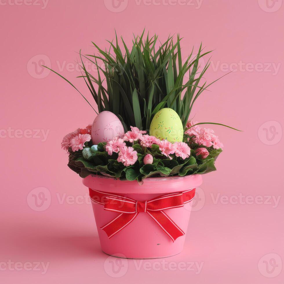 Easter eggs in a flower pot with grass on a pink background photo