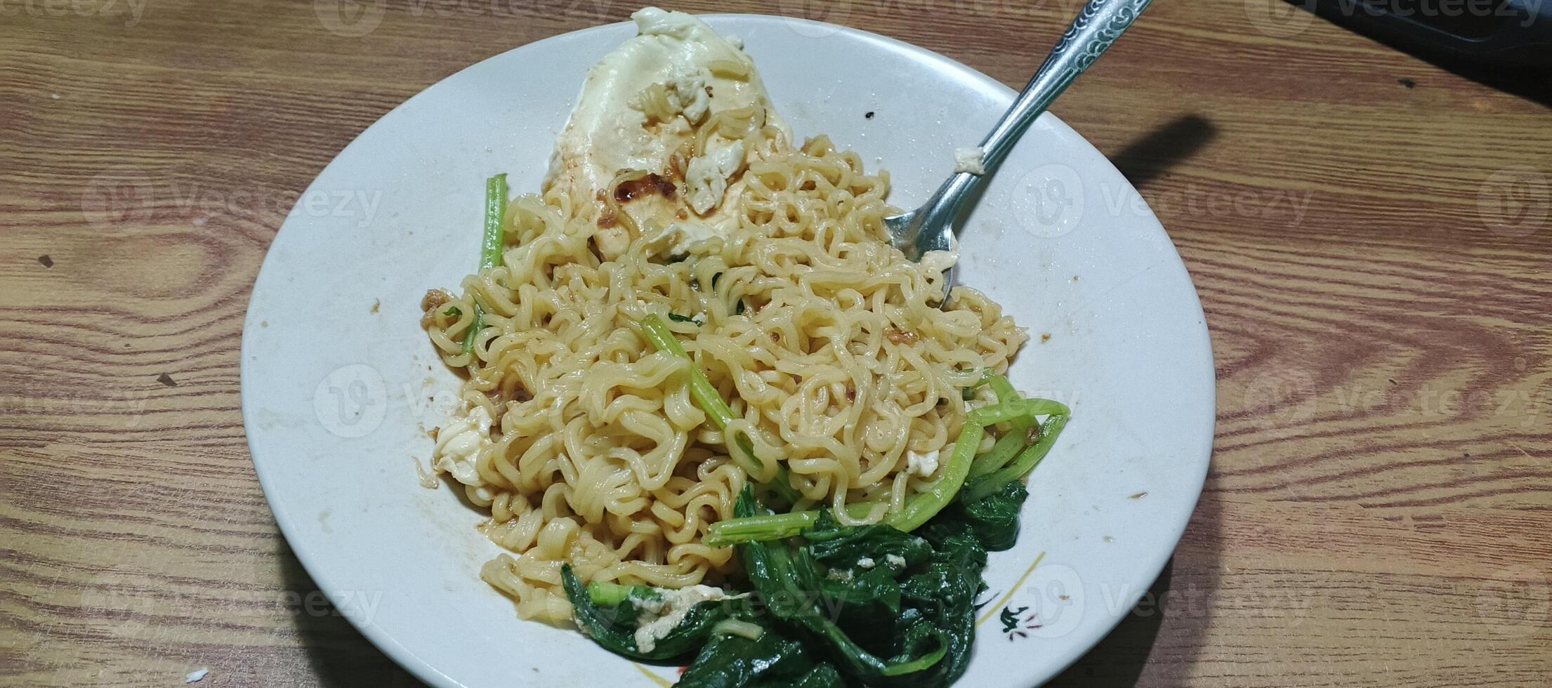 Close-up of cooked instant noodles with toppingsA detailed close-up of cooked instant noodles with toppings, showing texture and ingredients, perfect for food-related projects. photo