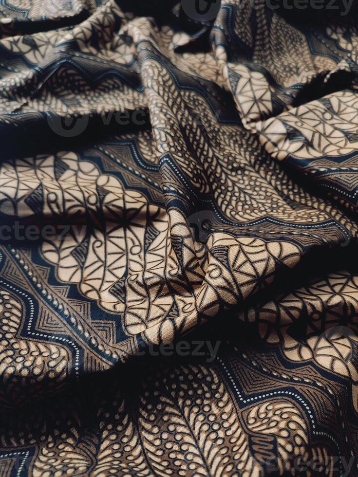 a close up of a black and gold patterned fabric photo