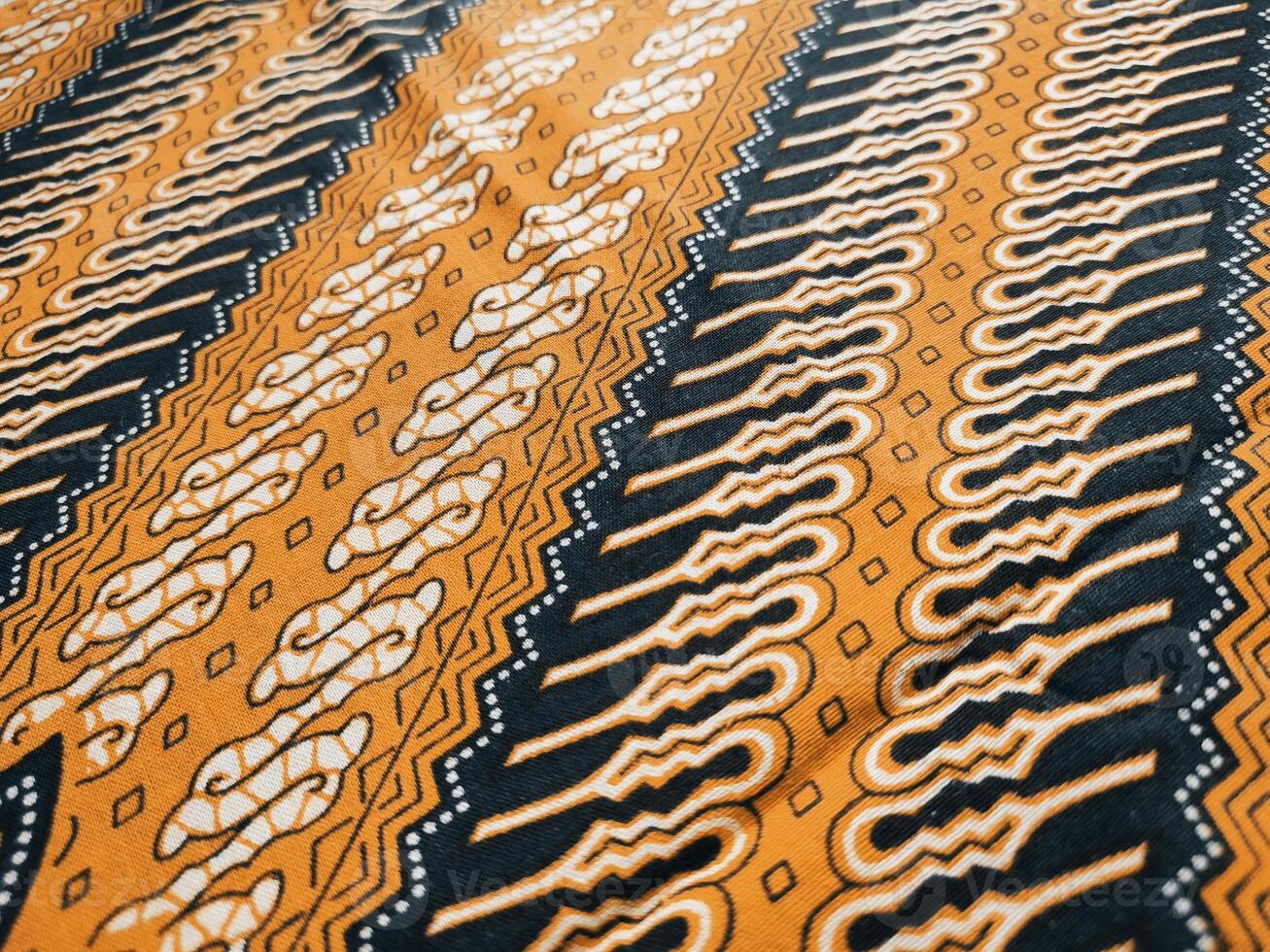 a close up of a black and orange fabric with a pattern photo