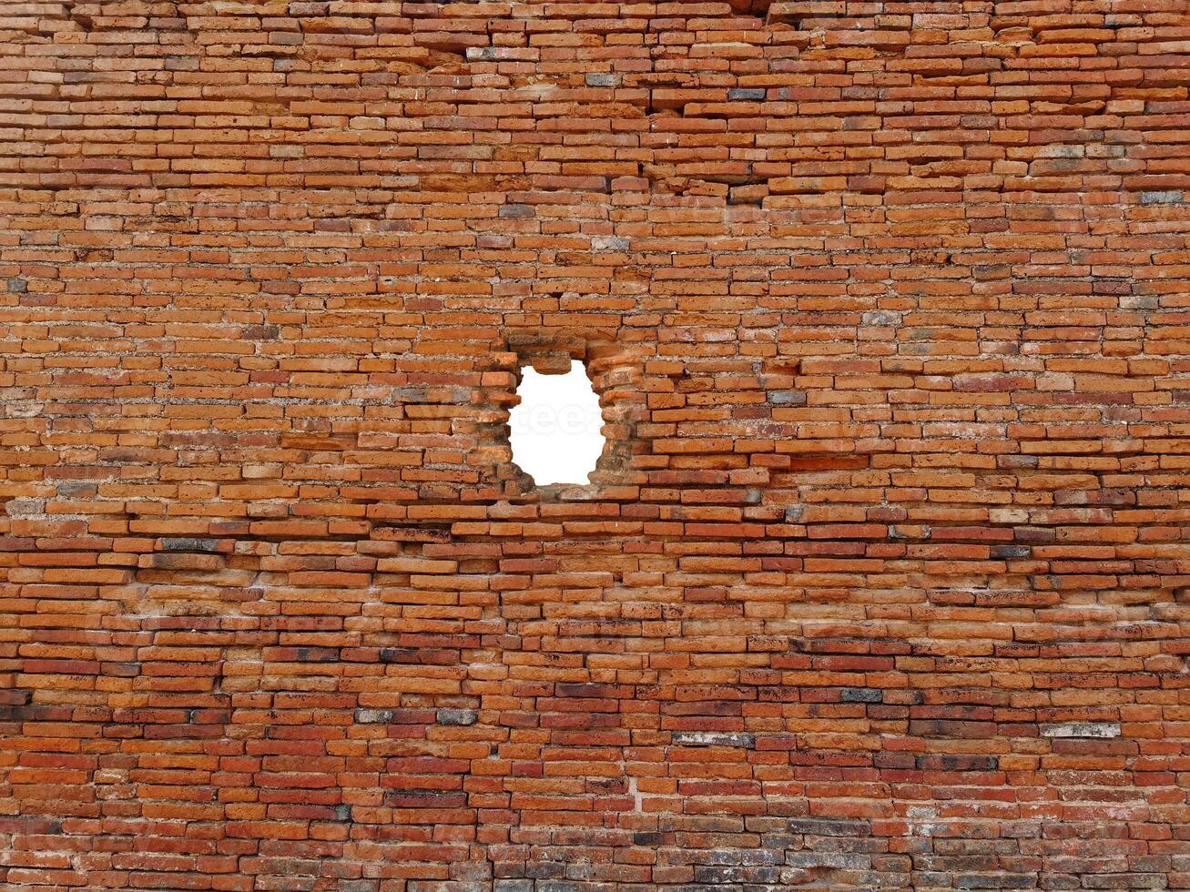 Holes in ancient brick walls, holes on the surface of ancient red bricks photo