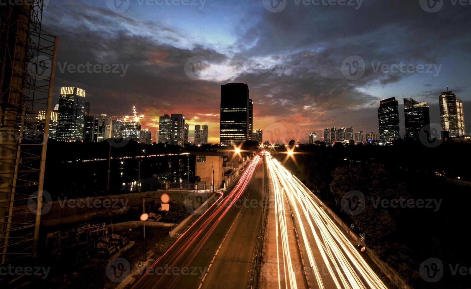 Light trails on the busy street at sunset in Jakarta, Indonesia photo