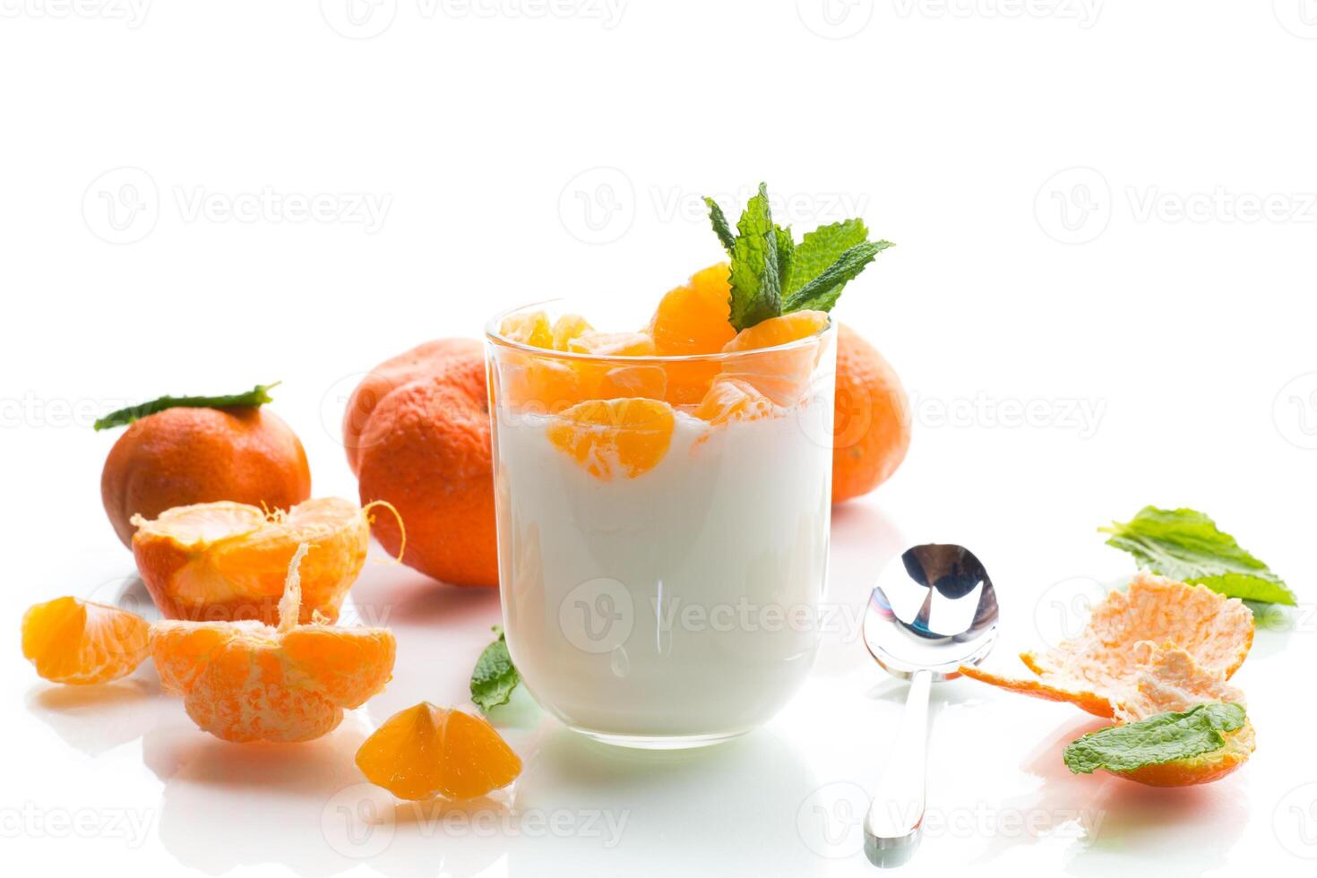 Creamy yogurt with tangerine slices, isolated on white background photo