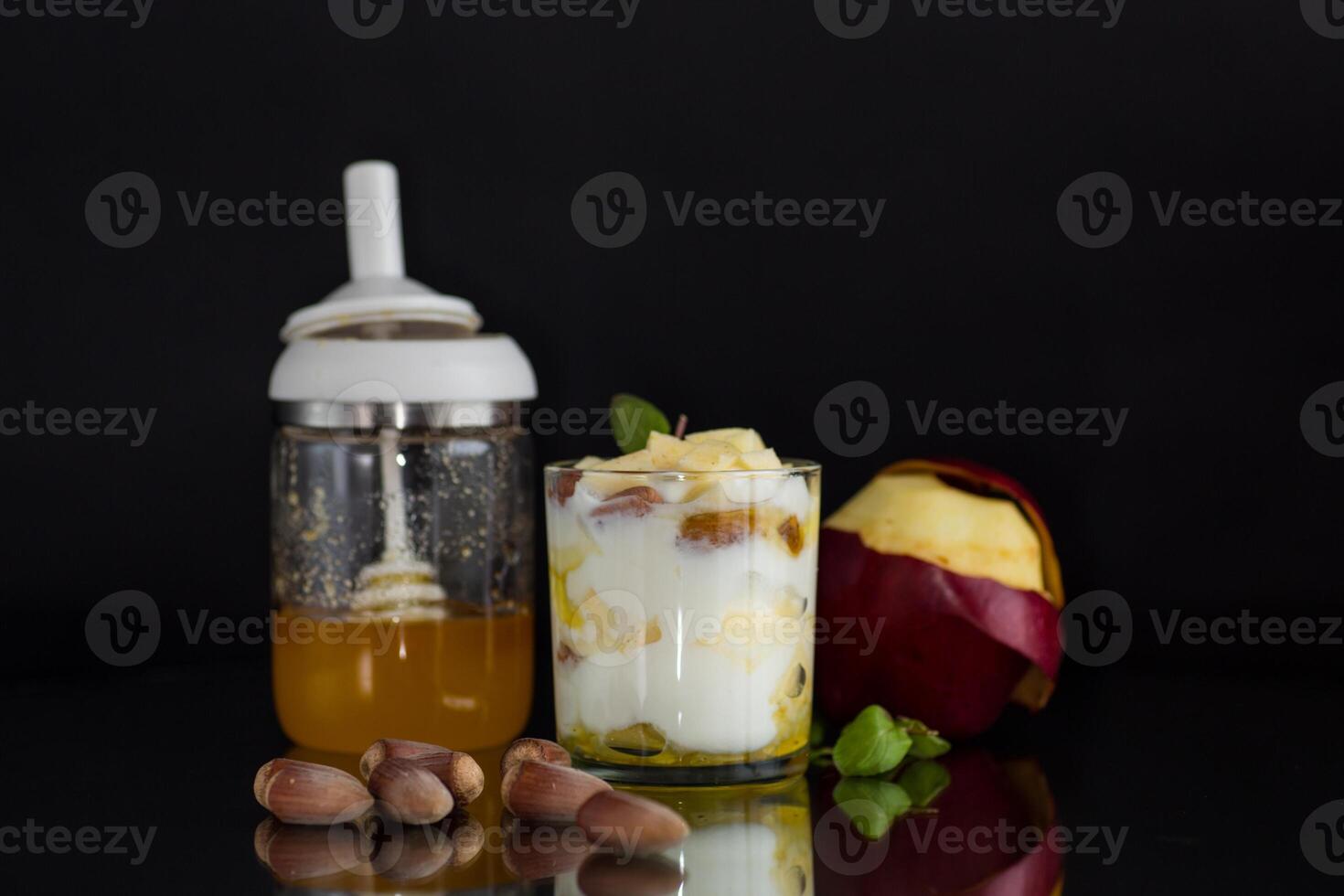 Diet food. sweet homemade yogurt in a glass with apples, nuts and honey photo