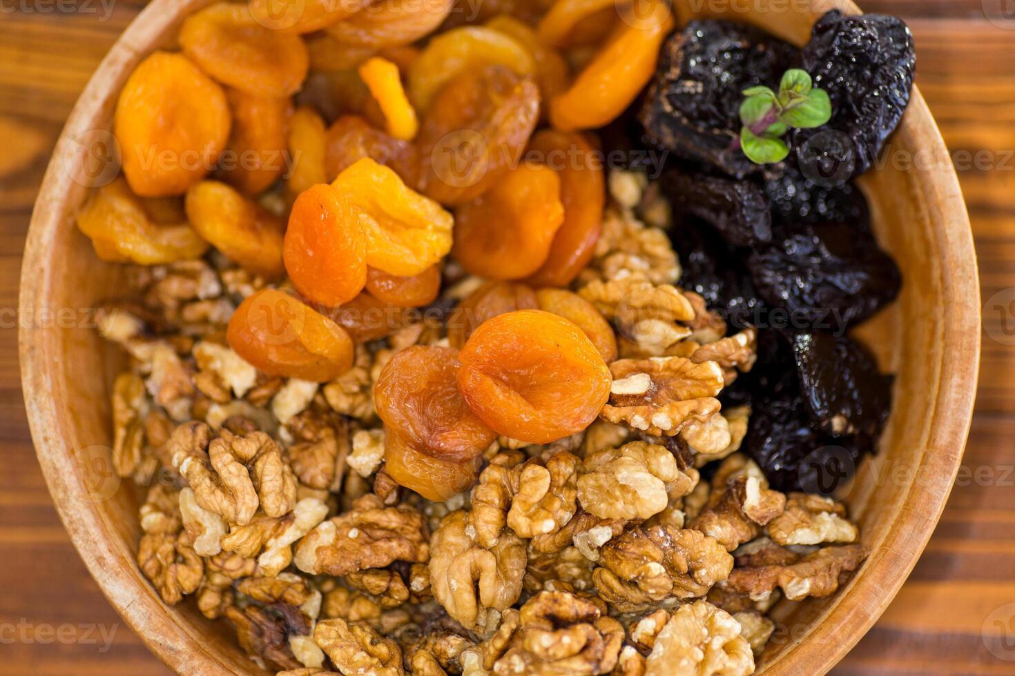 Natural dried Prunes, dried apricots and nuts close-up in macro photography photo