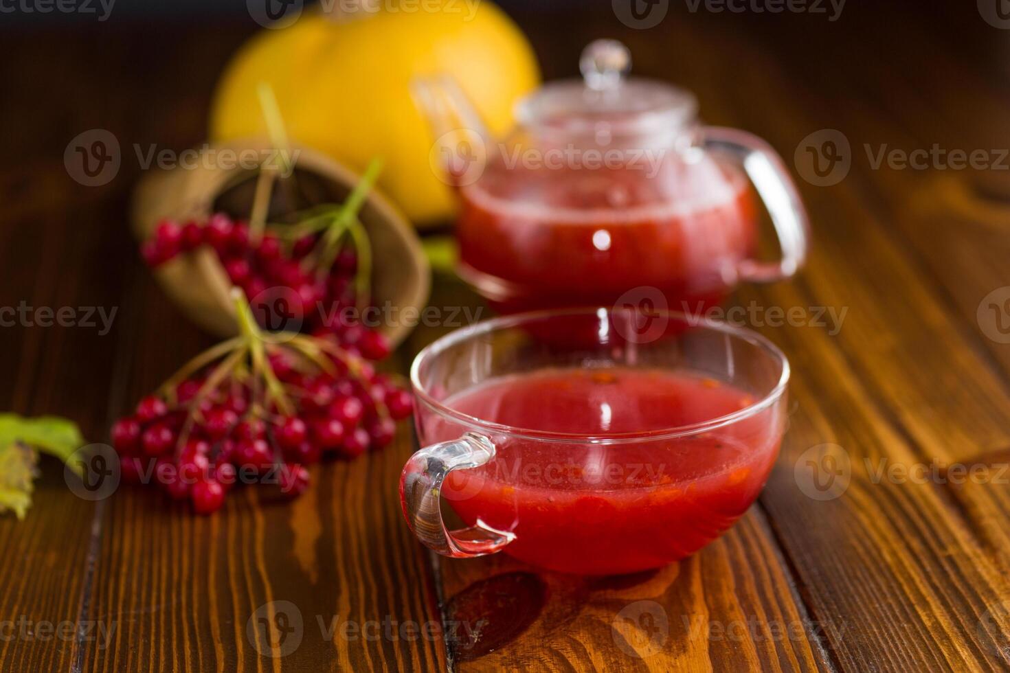 Healing vitamin tea. tea from ripe red viburnum on a wooden table photo