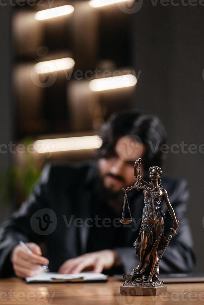 Themis, scales of justice close-up on the desk. Successful African American Attorney Lawyer using a laptop, computer in a courtroom setting. Justice and law, court judge. Vertical photo