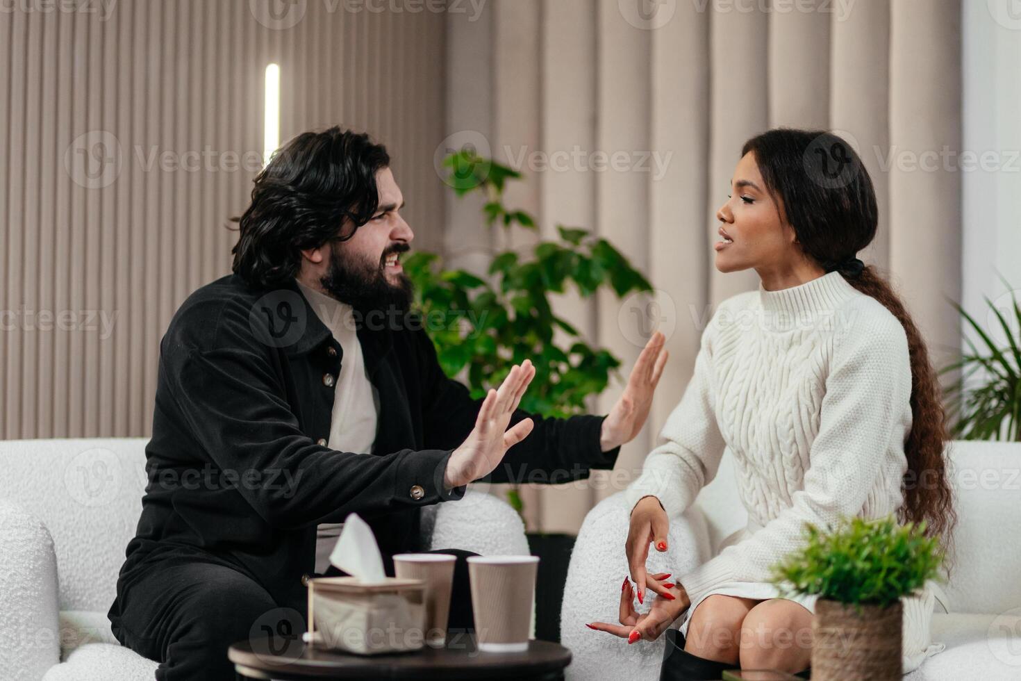 Angry husband and african american wife, biracial couple fighting discussing family problems during session with therapist in office. Relationship and psychology concept photo