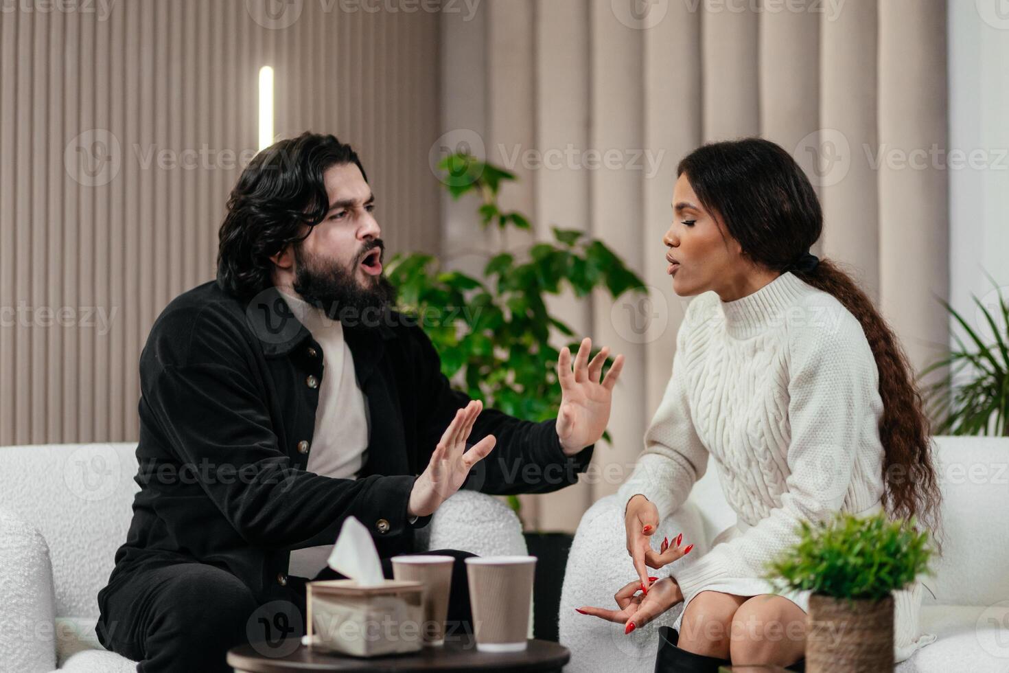 Angry husband and african american wife, biracial couple fighting discussing family problems during session with therapist in office. Relationship and psychology photo