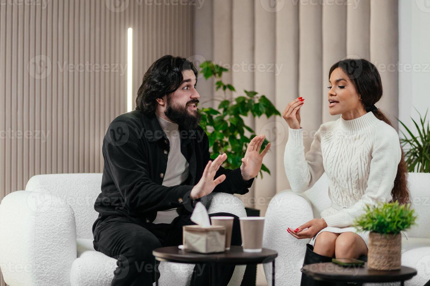 Man and black, african woman argue with each other at a consultation with a psychologist. Multiracial couple, misunderstanding. Psychological therapy, survive personal crisis, relationships concept. photo