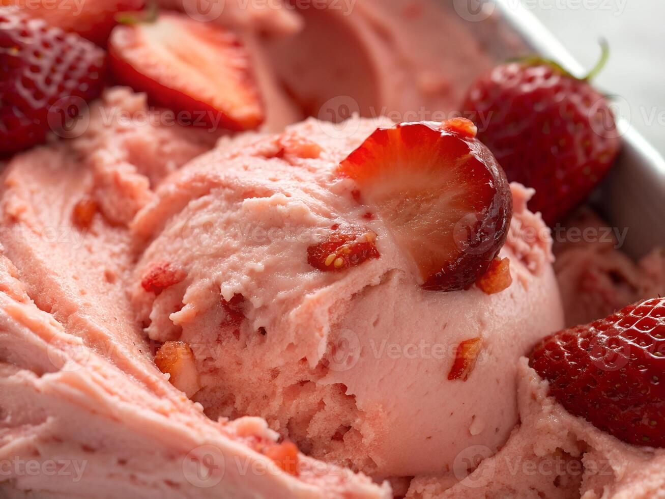 A scoops of strawberry ice cream topped with fresh strawberry in a white bowl photo