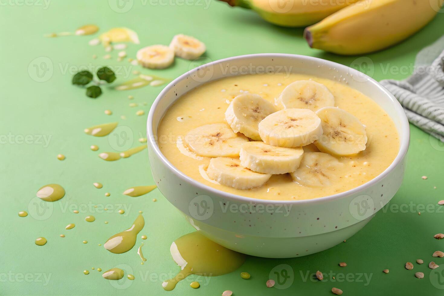 A bowl filled with smooth banana puree topped sliced bananas photo