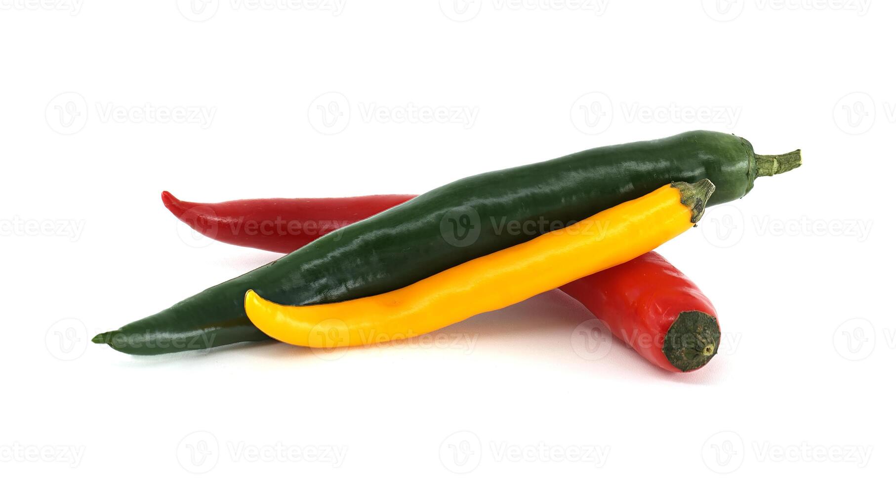 Three chili peppers forming a colorful and spicy composition on white background photo