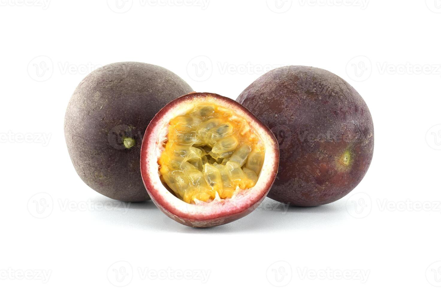 Two passion fruits and a half showing the pulp on a white background photo