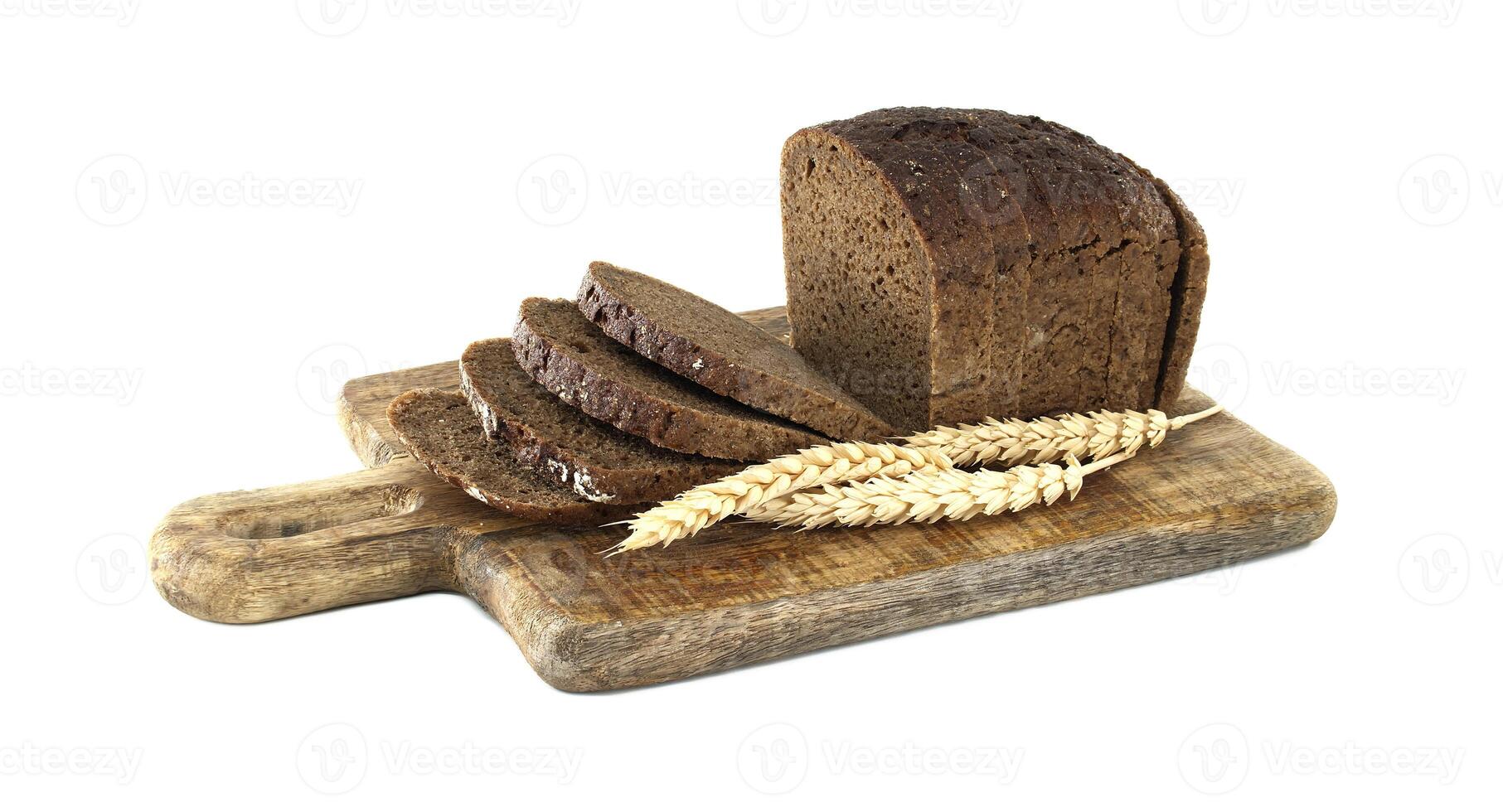 Sliced Whole Grain Rye Bread on Wooden Board with Wheat Sprig photo