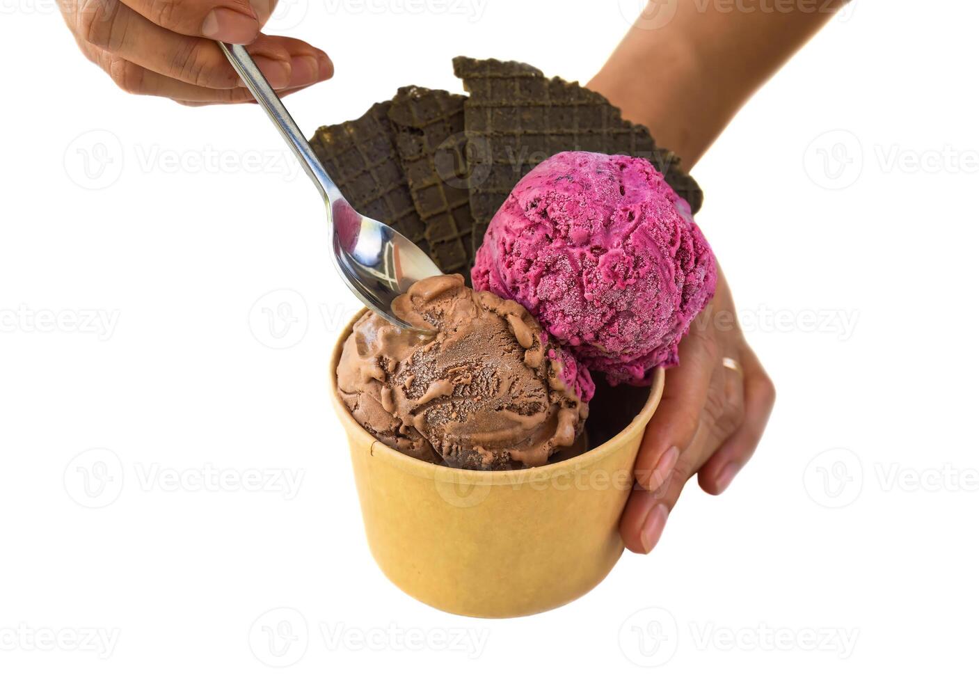 Hand with spoon holding piece of homemade ice crem Tiramisu and Hibiscus isolated on white background photo