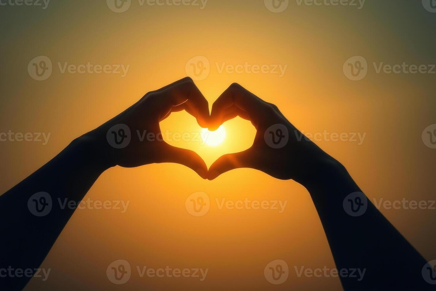 Romantic Heart Shaped Hands Silhouette with Glowing Sunset Light Symbolizing Love and Connection in Warm Golden Hues photo