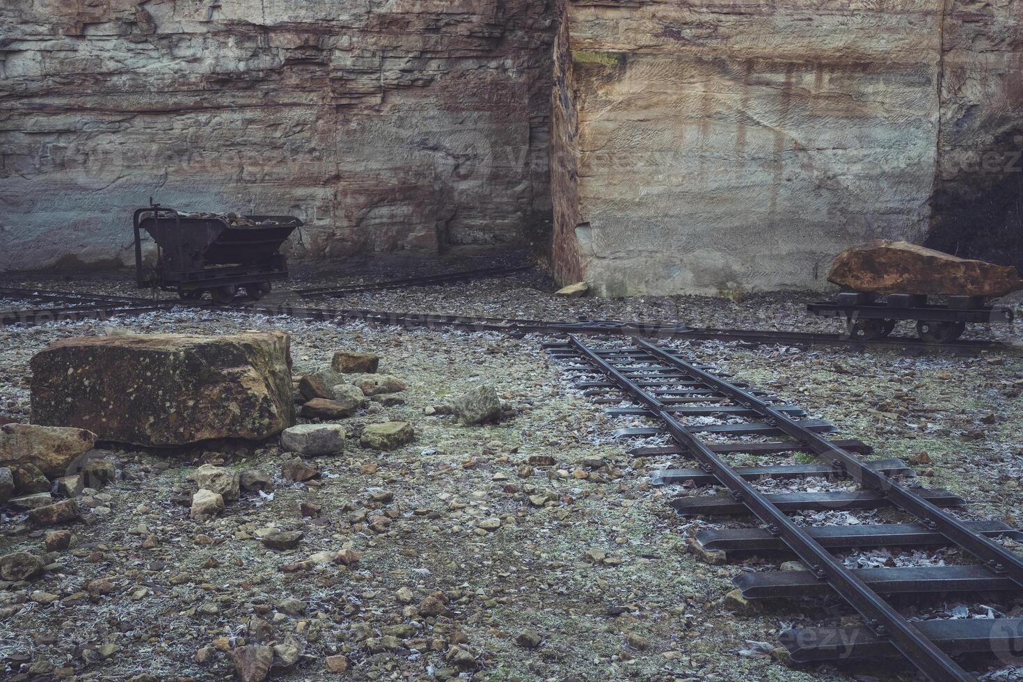 Remnants of a bygone era found in an abandoned quarry with old tracks and mining equipment photo