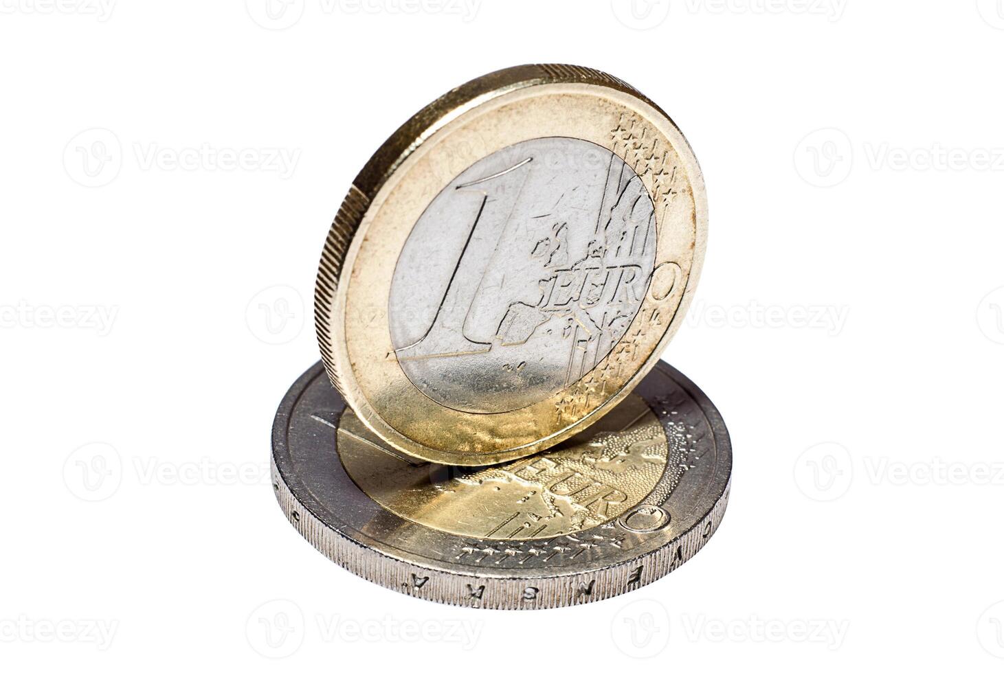 Coin of one euro to another euro coin close up photo