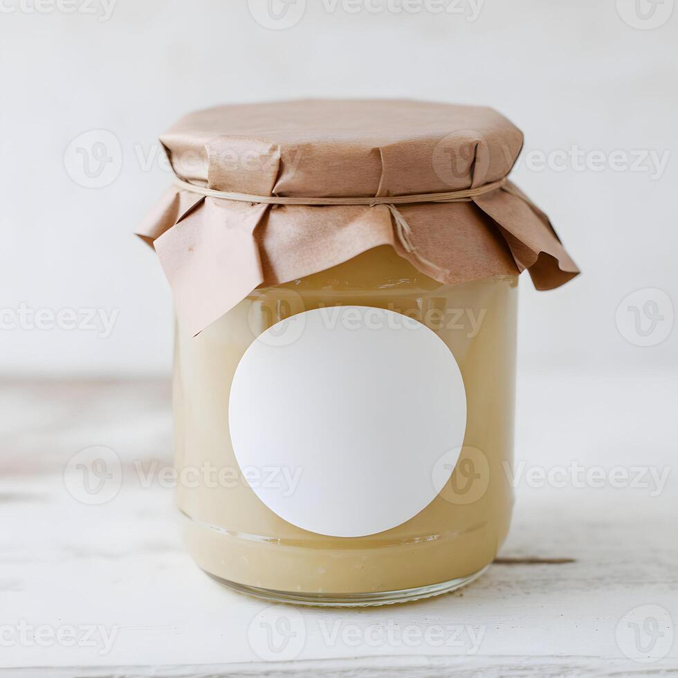 Glass Jar with Yellow Preserve Rustic glass jar with yellow preserve on simple white surface For Social Media Post Size photo