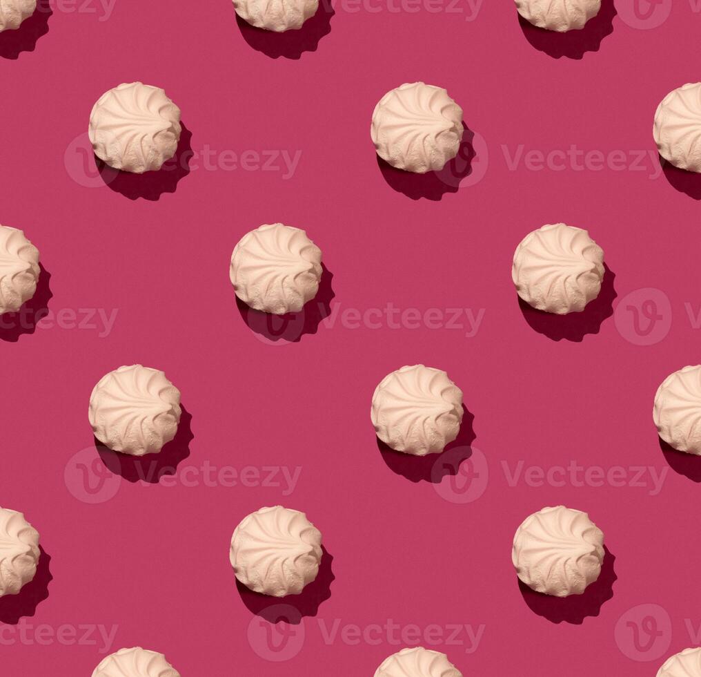 Pink soft marshmallow on pinky background, zephyr on a pink background. Seamless Zephyr Pattern with hard shadow photo