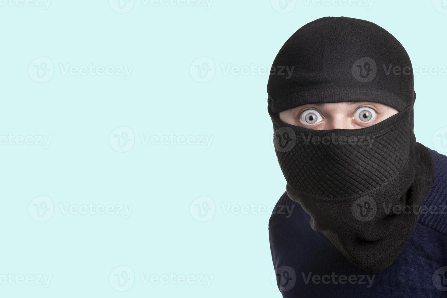 criminal in balaclava on blue photo