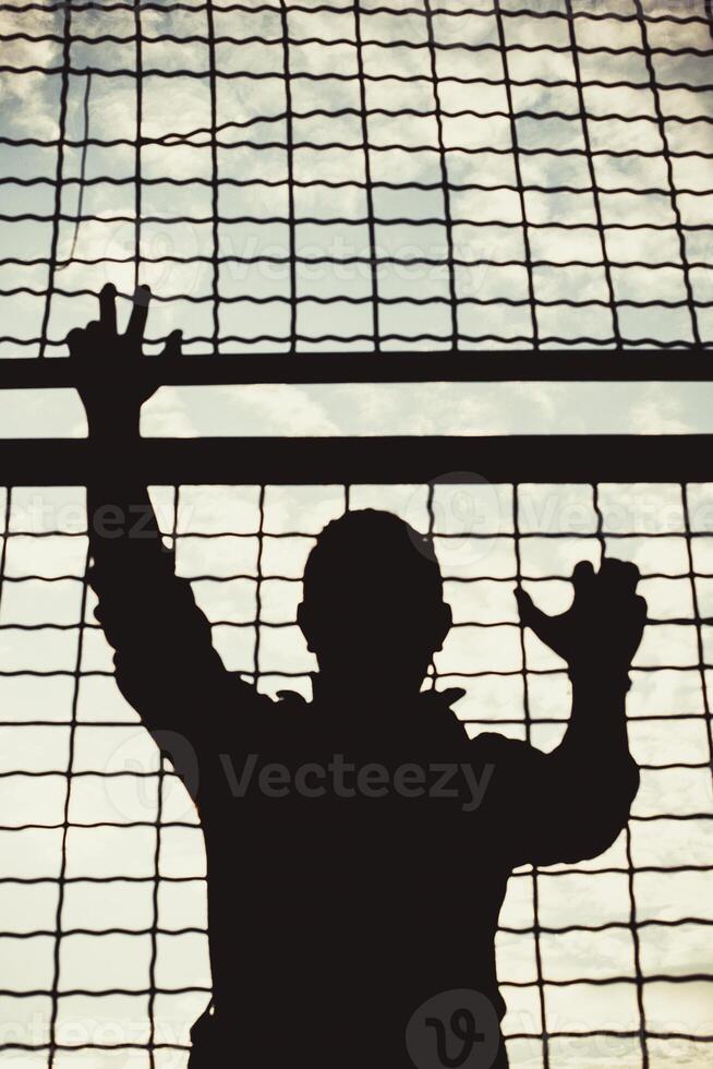 behind metal bars closeup photo