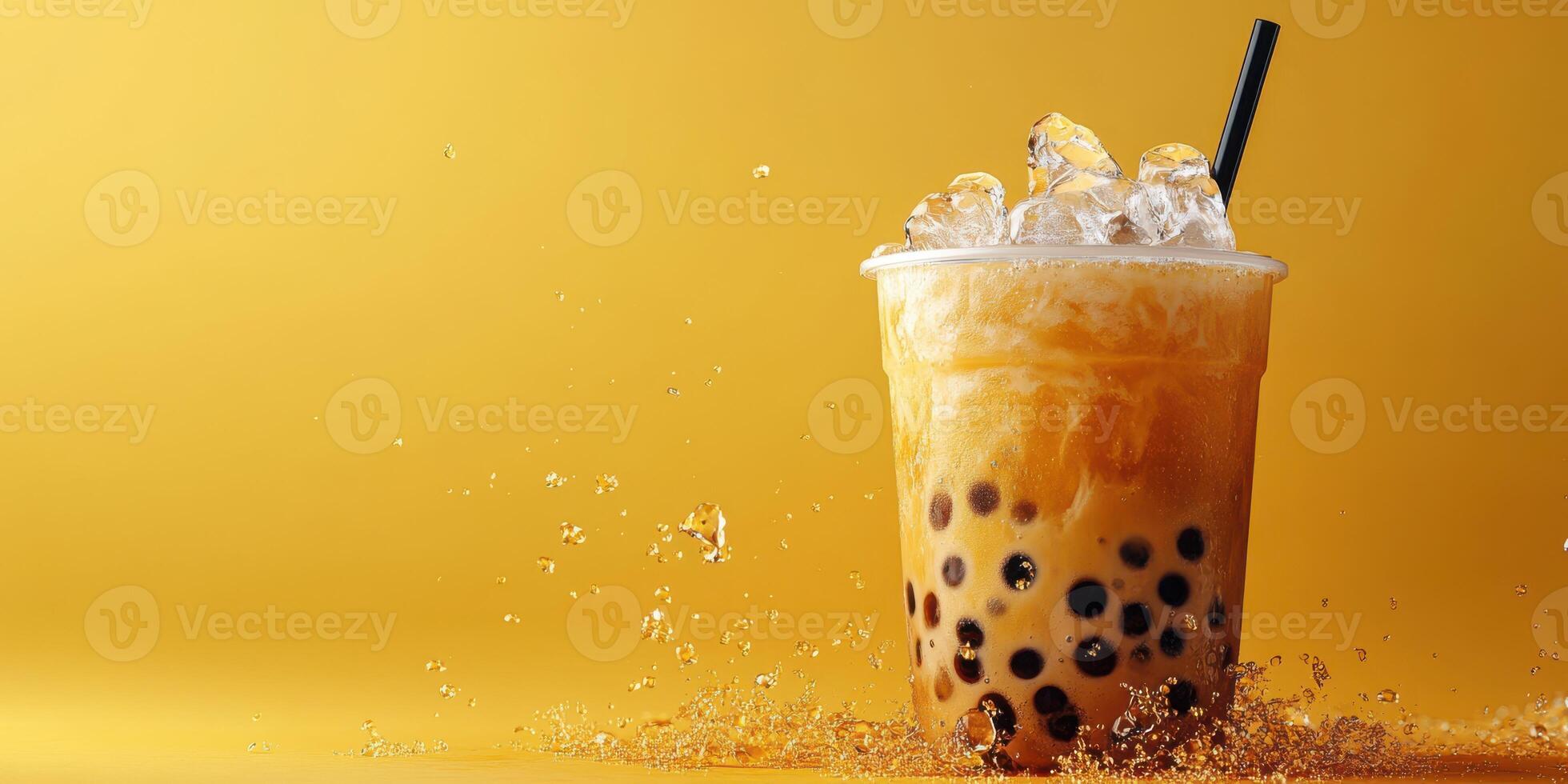 Refreshing bubble tea with ice on a vibrant yellow background, showcasing a popular drink at a cafe setting photo