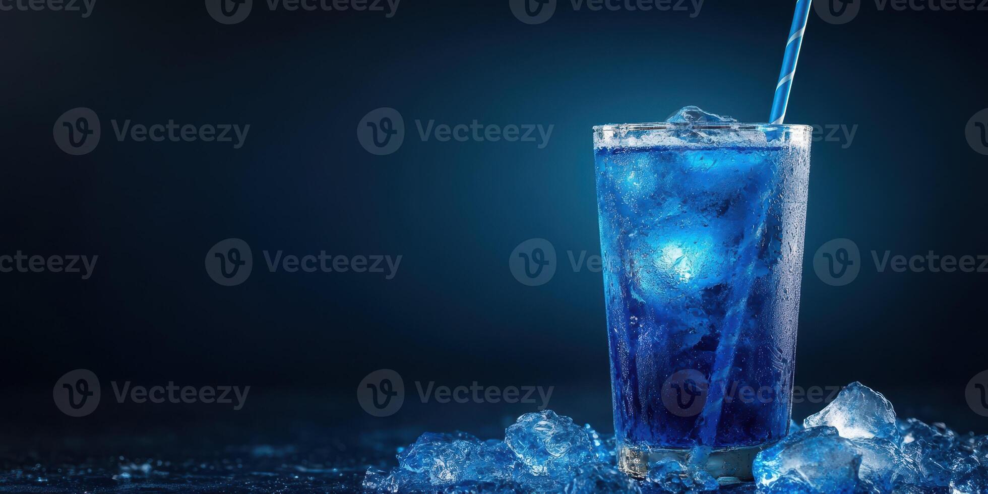 Refreshing blue cocktail in a glass with ice on a dark background photo