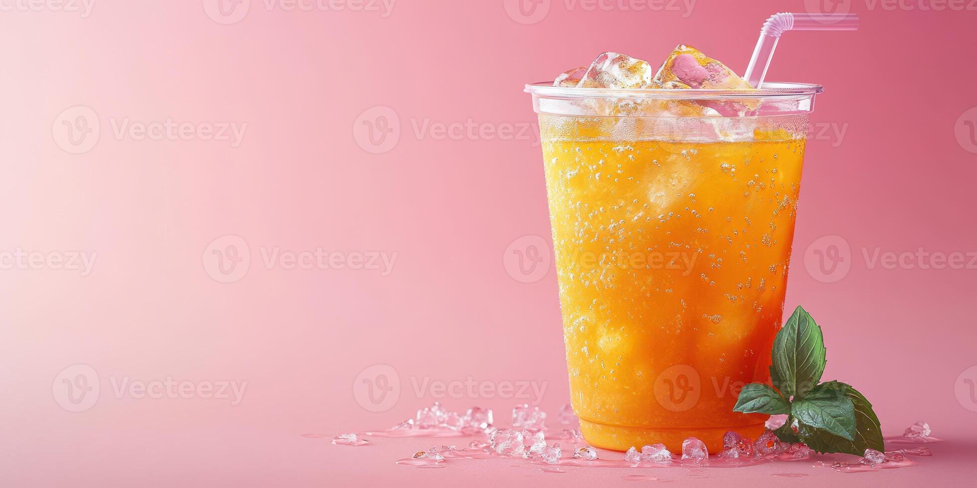 Refreshing fruity drink with ice and mint leaves on a pink background in a casual setting photo