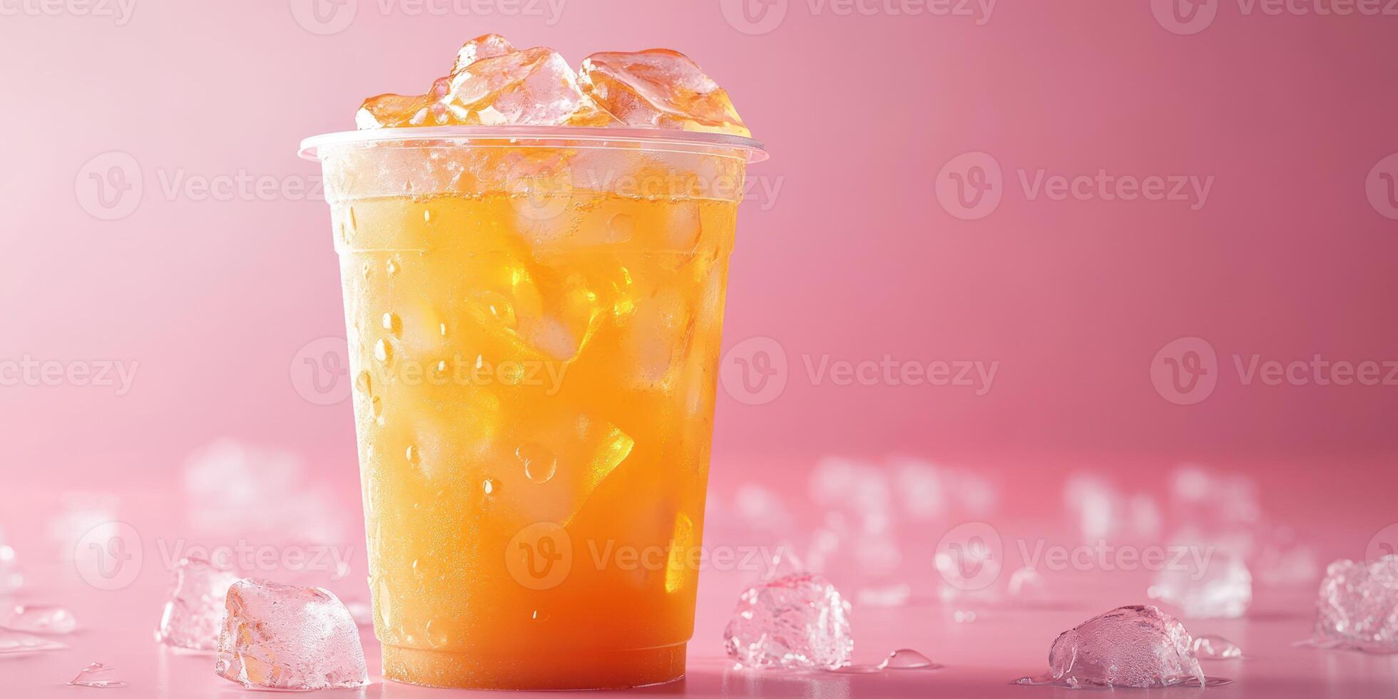 Refreshing iced drink with ice cubes on a pink background captured in a bright setting photo