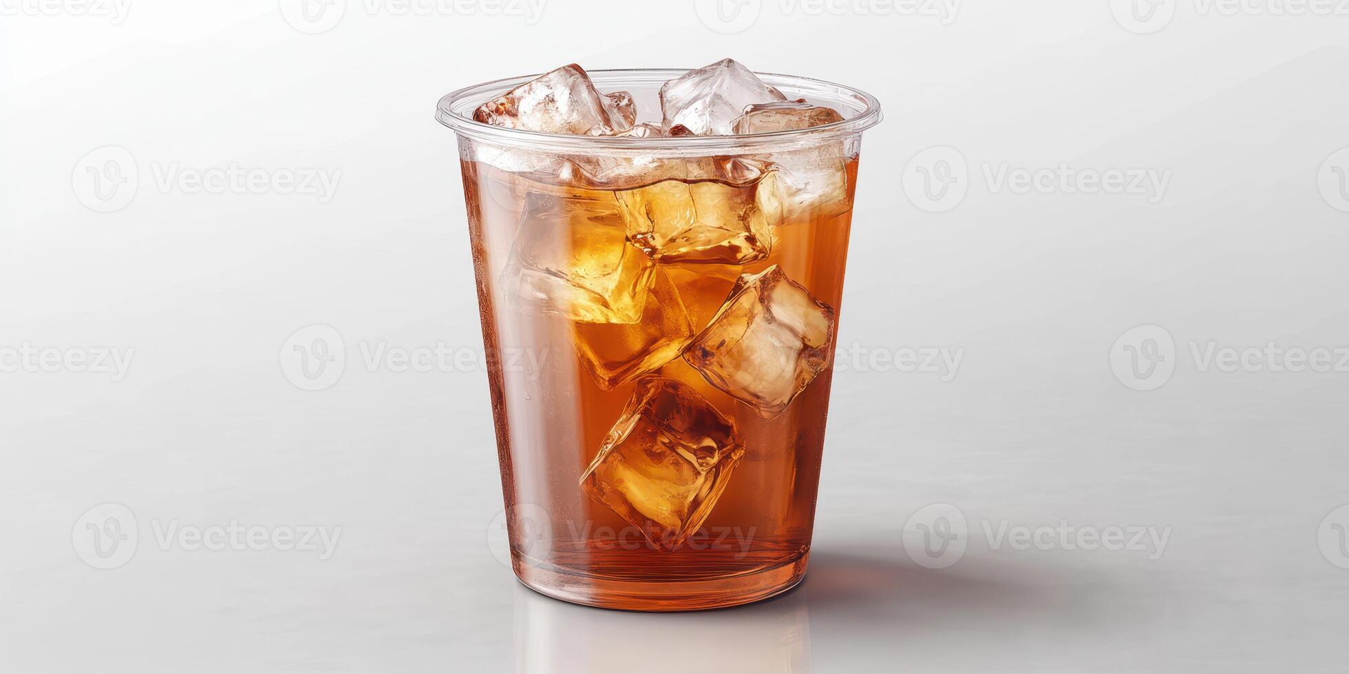 Refreshing iced tea in a clear plastic cup filled with ice cubes on a light background photo