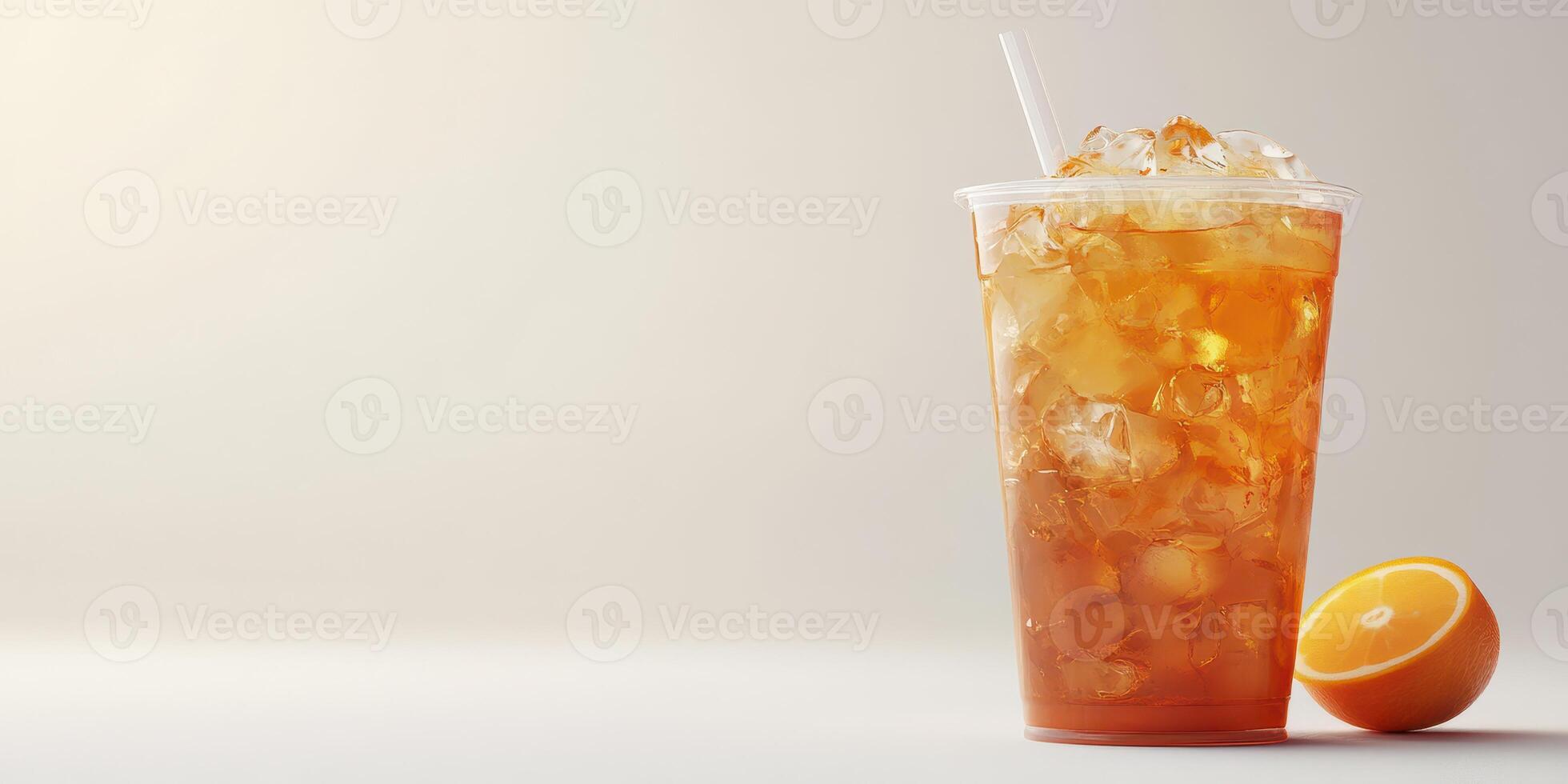 Refreshing iced tea served in a clear cup with a slice of orange beside it on a light background photo
