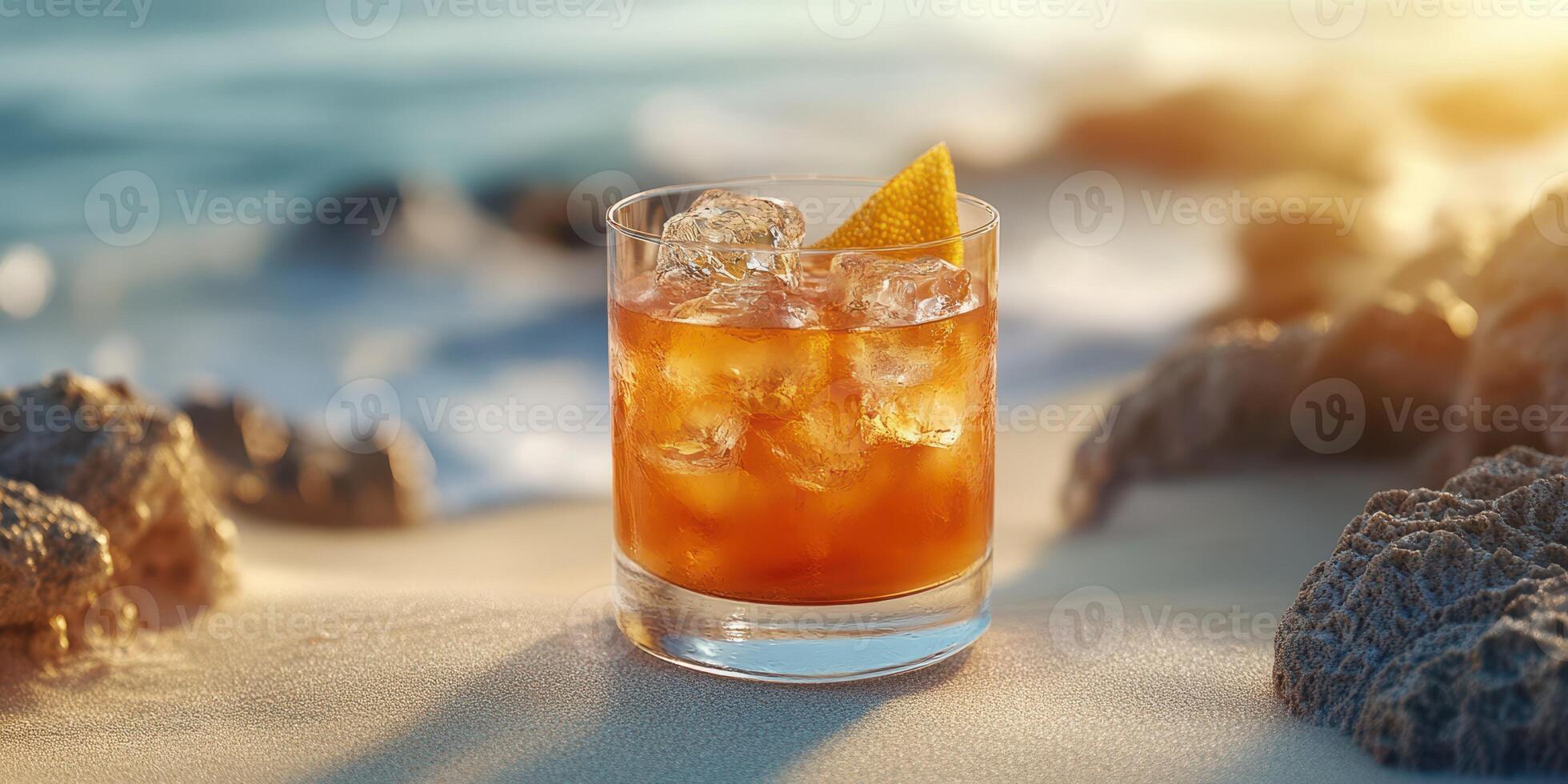 Cocktail on the Beach during Sunset with Orange Slice and Ice Cubes photo