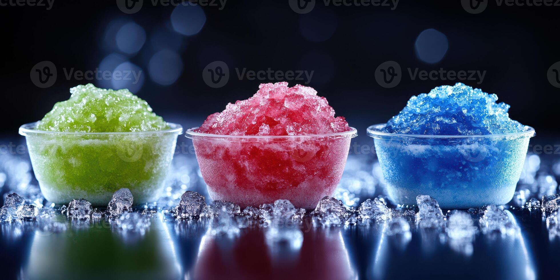 Colorful frozen treats displayed on a reflective surface with ice crystals in a dark setting photo