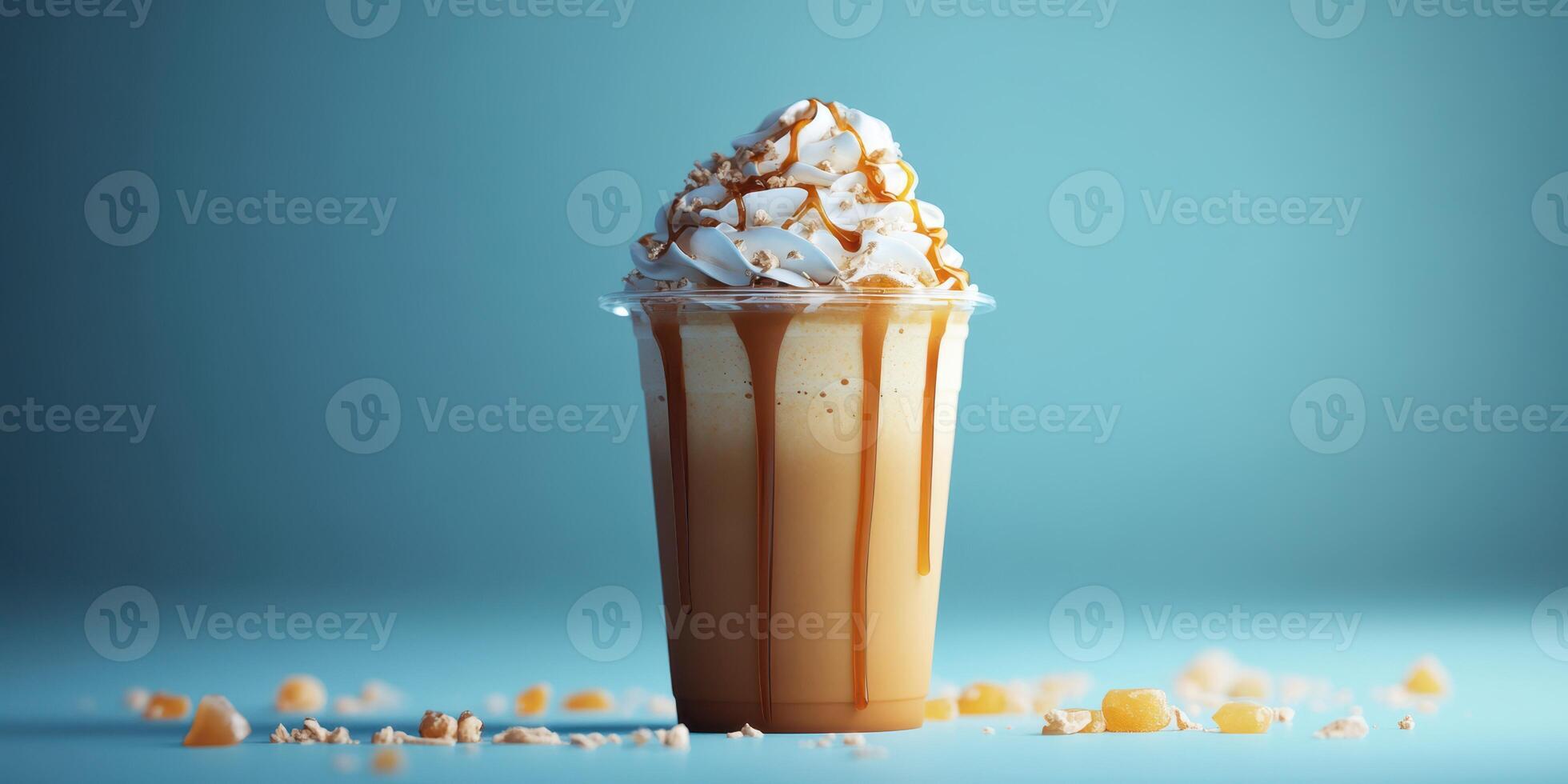 Delicious iced caramel drink topped with whipped cream and drizzled caramel on a blue background photo