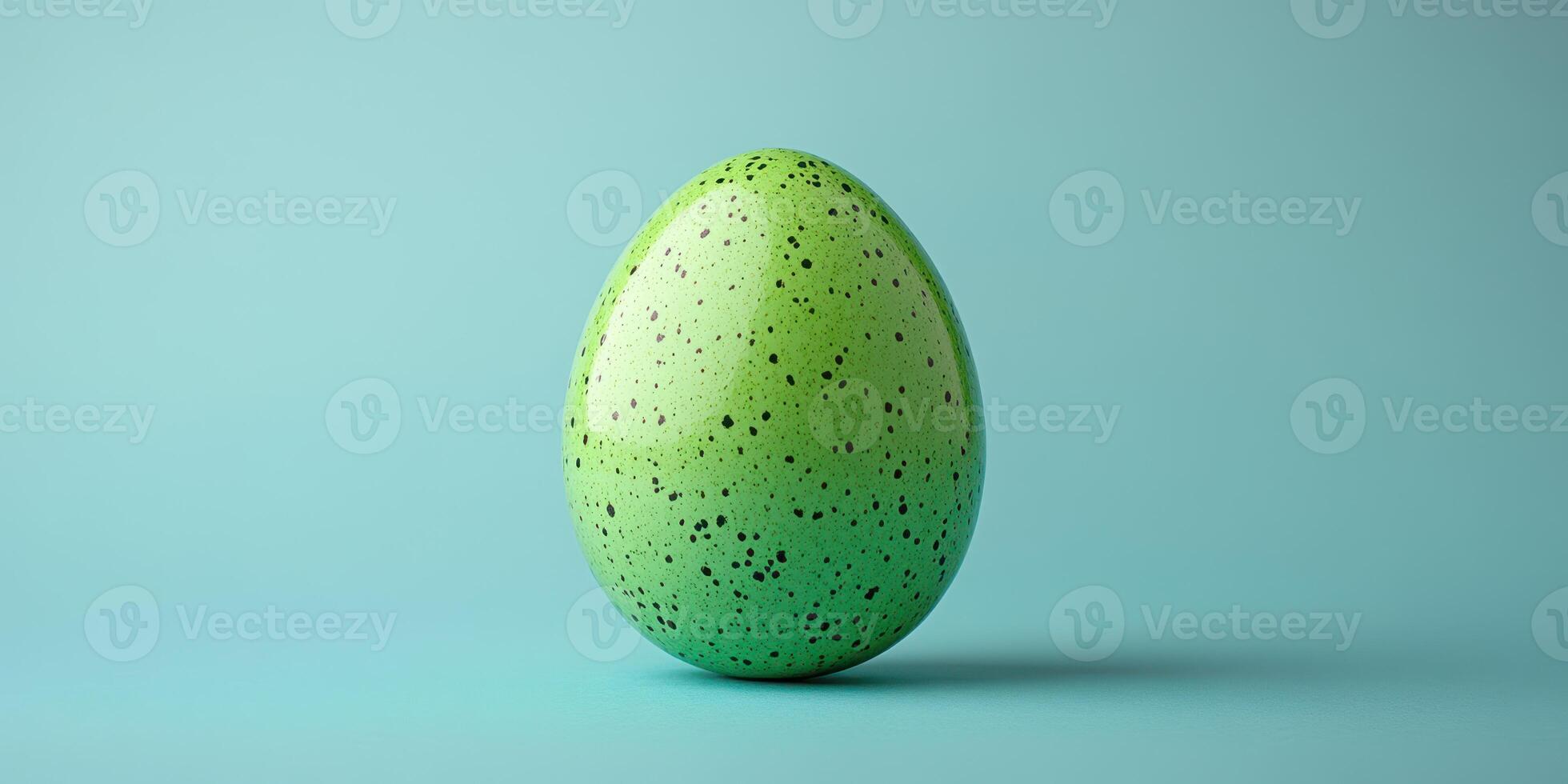 Colorful green speckled egg displayed against a light blue background in a minimalistic and artistic way photo