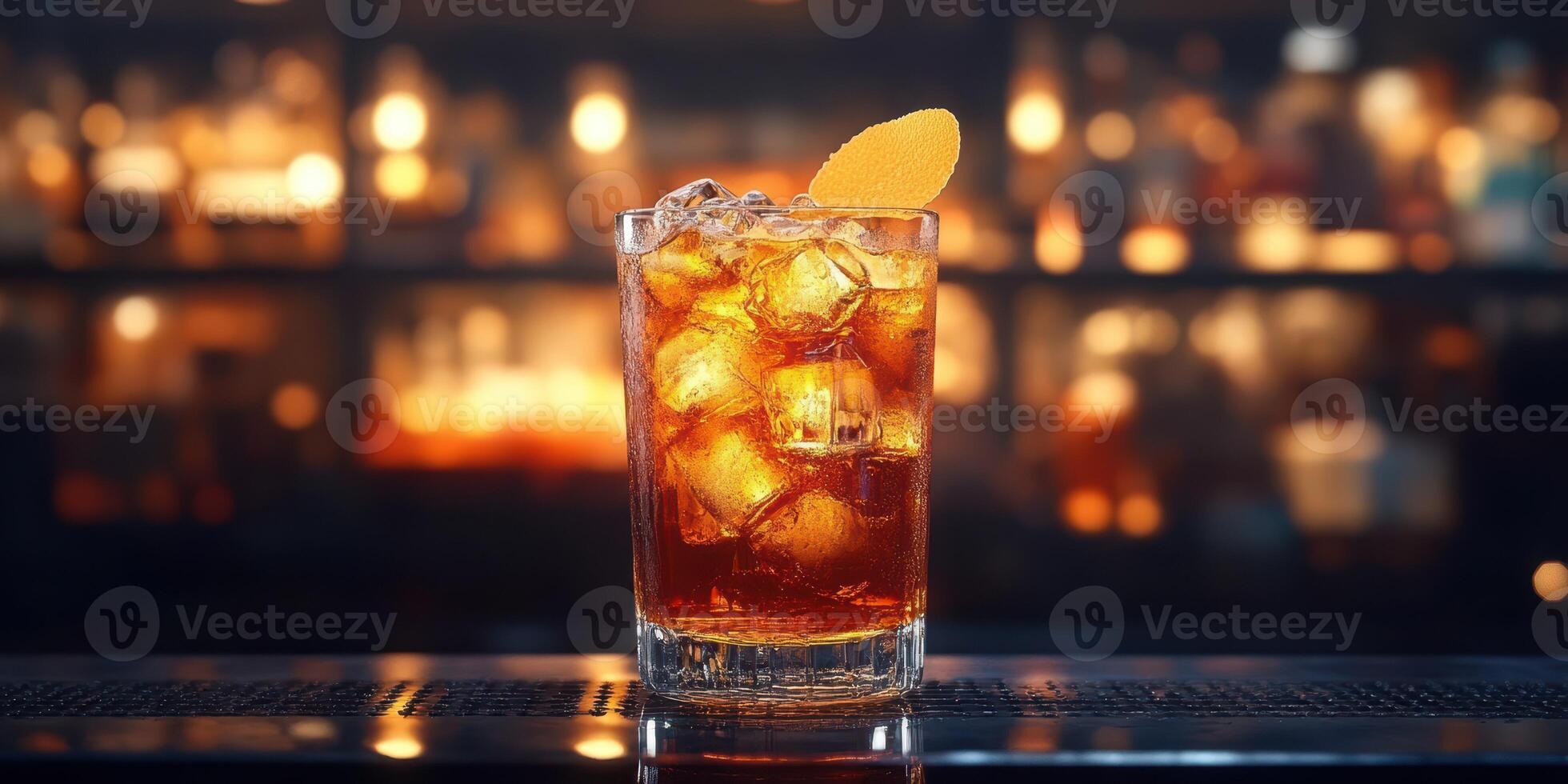 Classic cocktail with ice and orange garnish served in a cozy bar setting at night photo