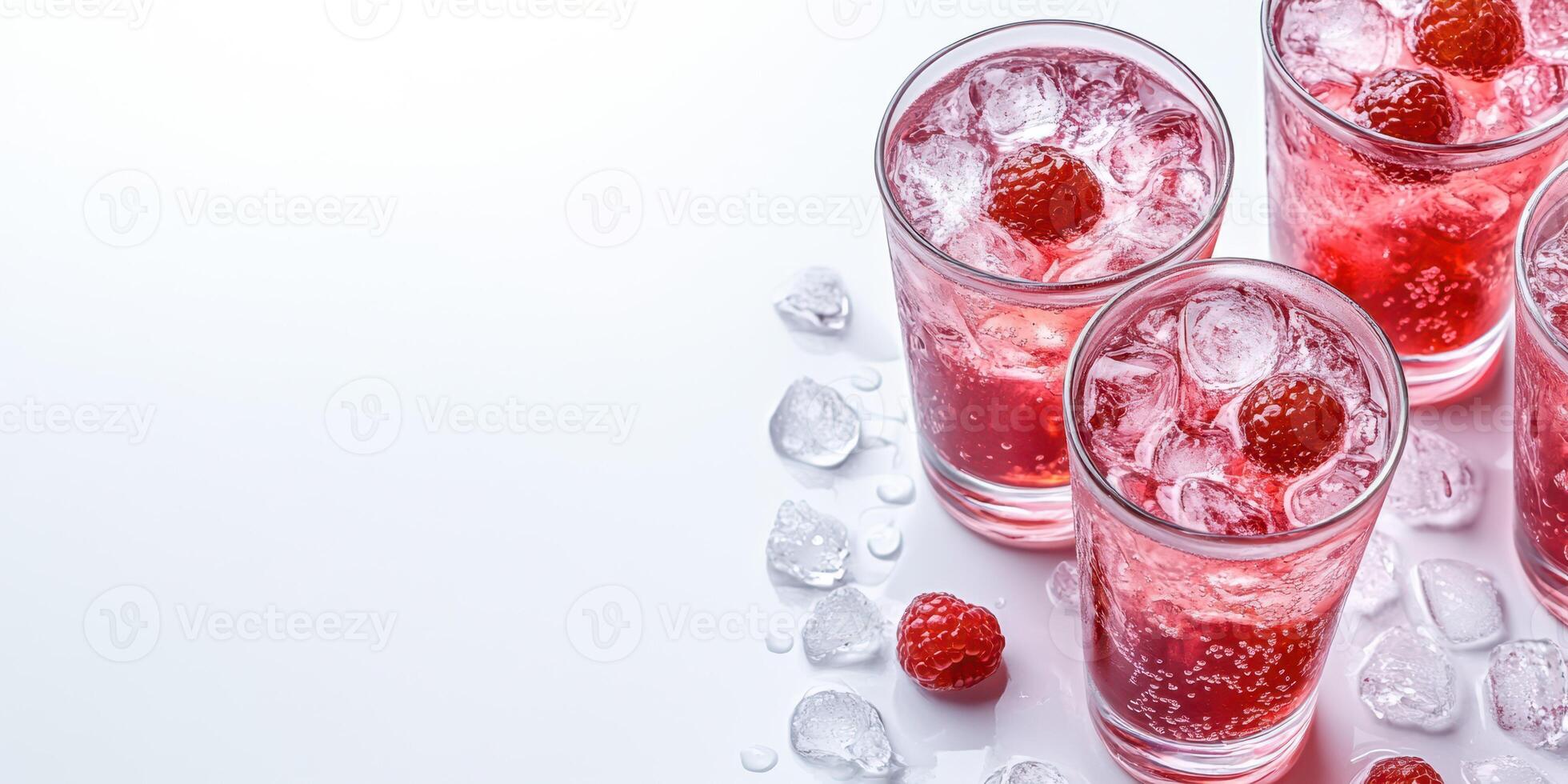Refreshing raspberry drinks served with ice in a clear glass on a white background during summer gatherings photo