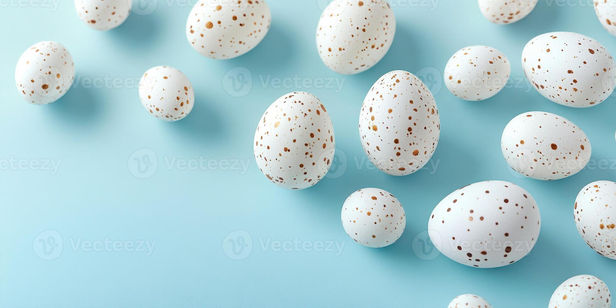 Decorative white eggs with golden speckles arranged on a light blue surface, ideal for a festive celebration or craft project photo