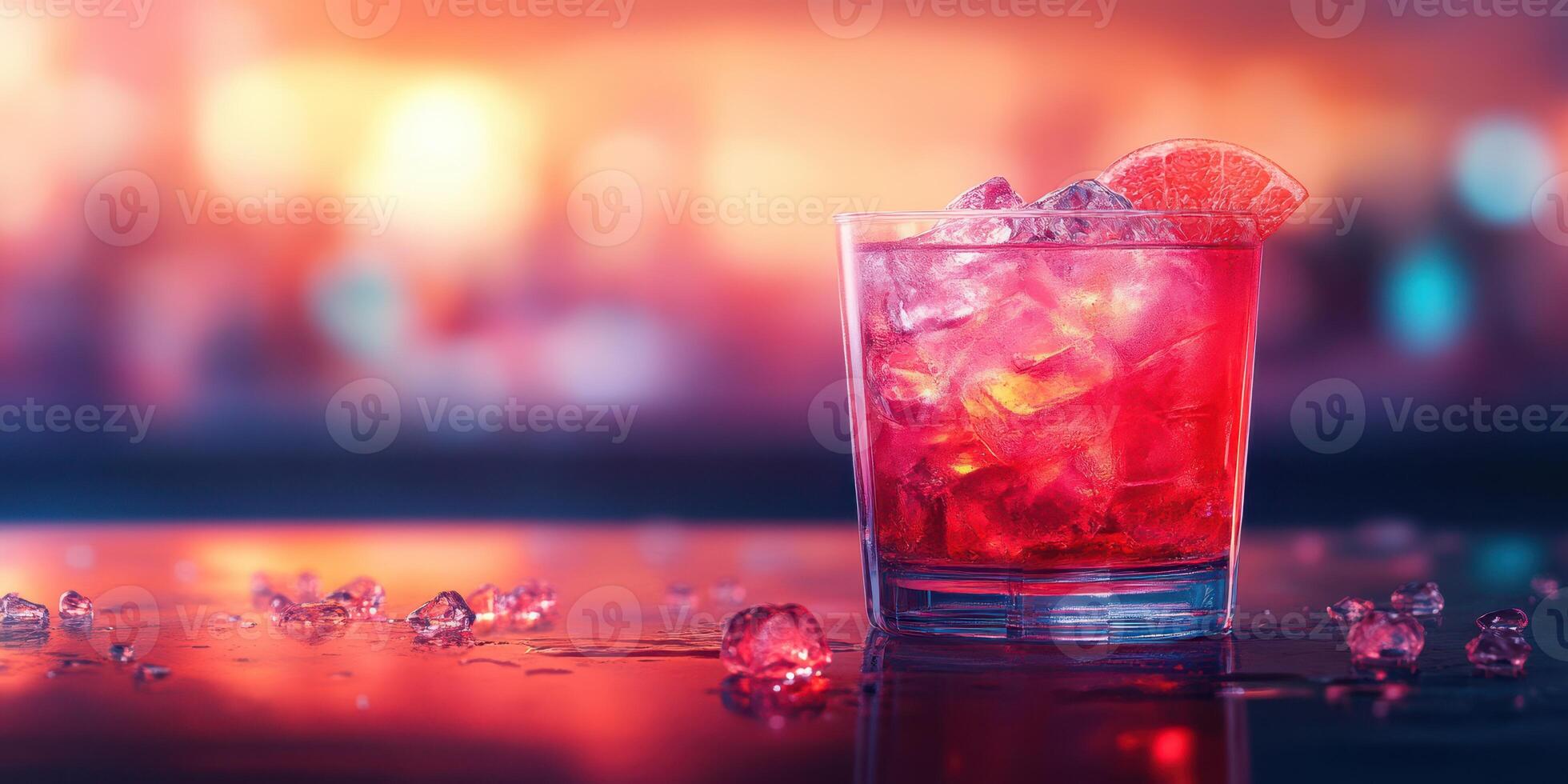 Refreshing cocktail served in a glass with ice and a slice of citrus fruit at a lively bar during evening hours photo