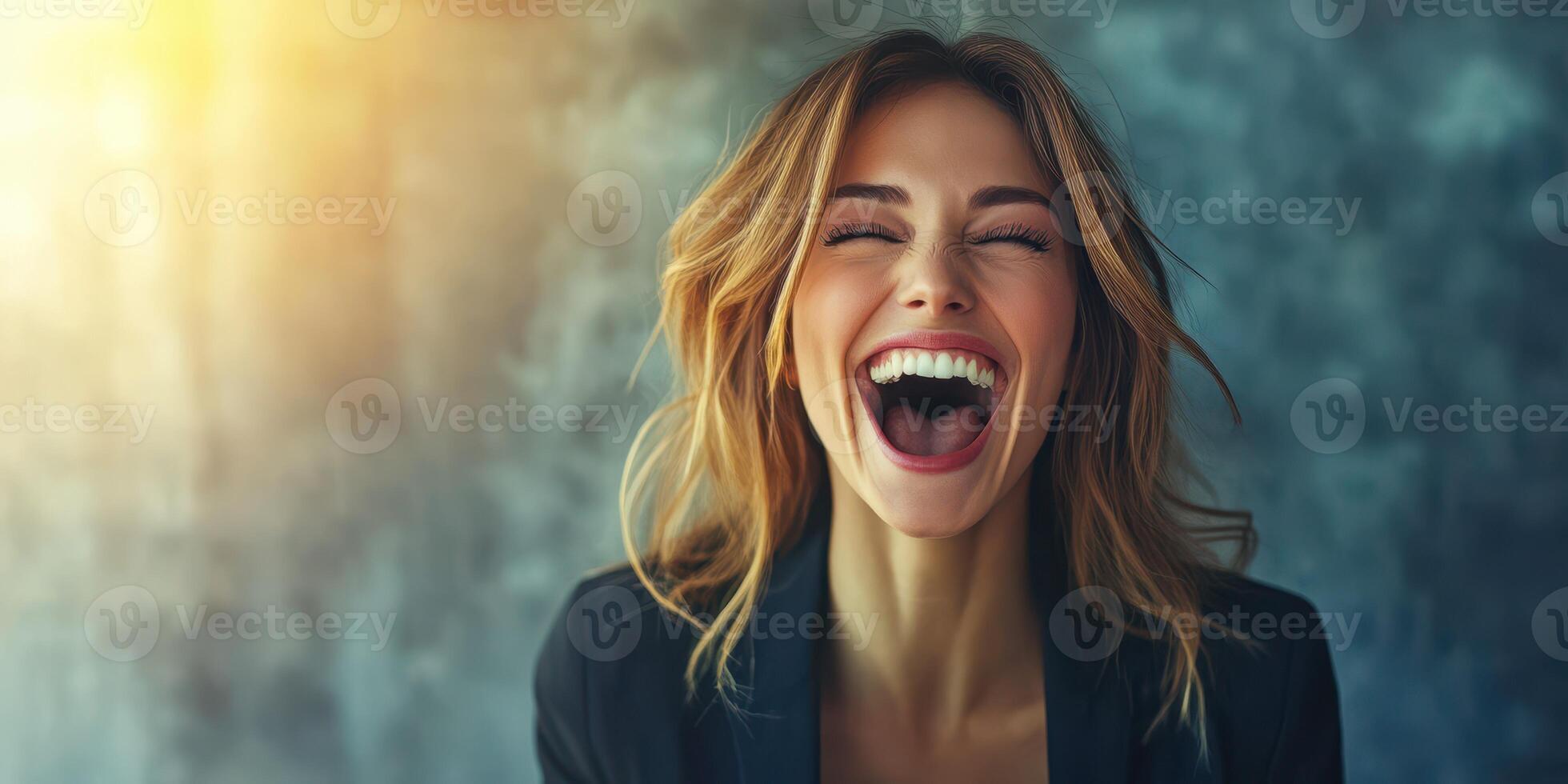 Joyful woman laughing brightly in a modern indoor setting during daylight hours photo