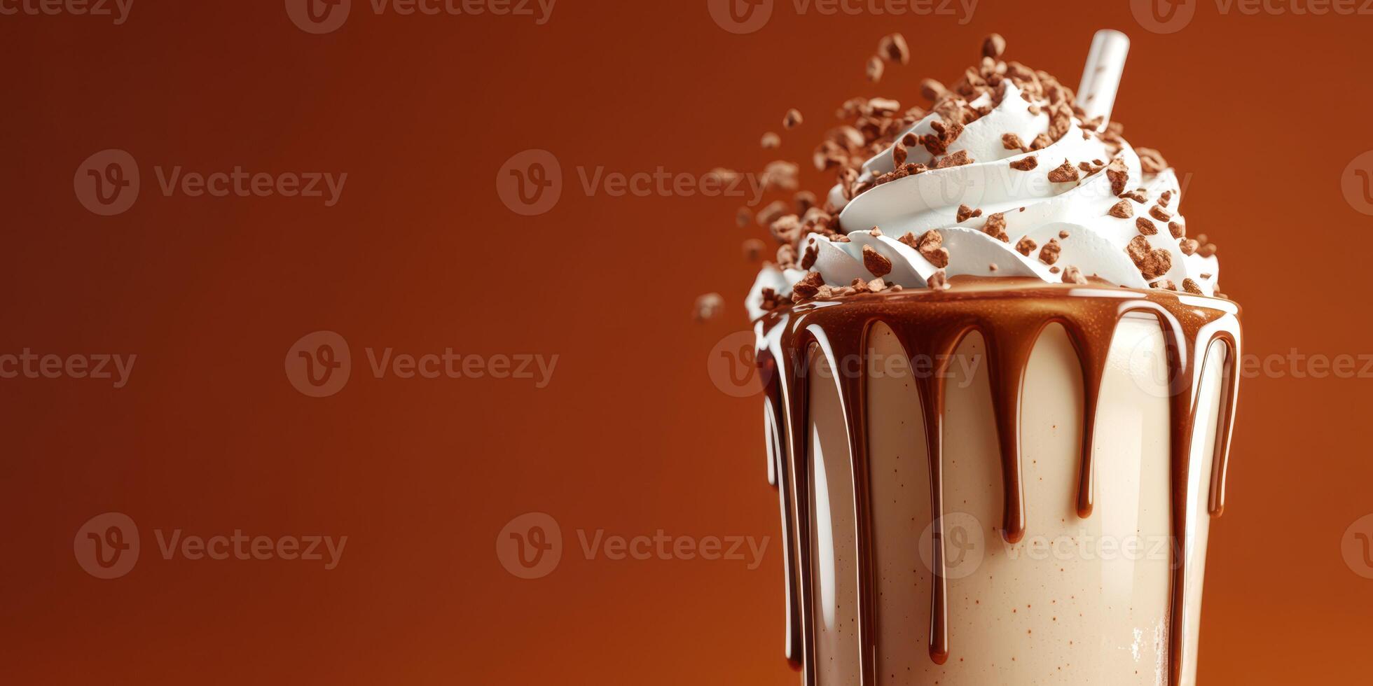 Creamy chocolate milkshake topped with whipped cream and chocolate shavings on orange background photo